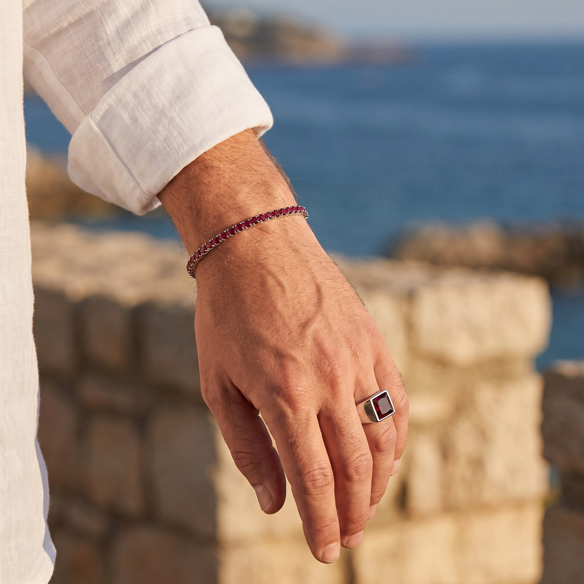 Rubi Garnet Signet Ring worn with the matching tennis bracelet