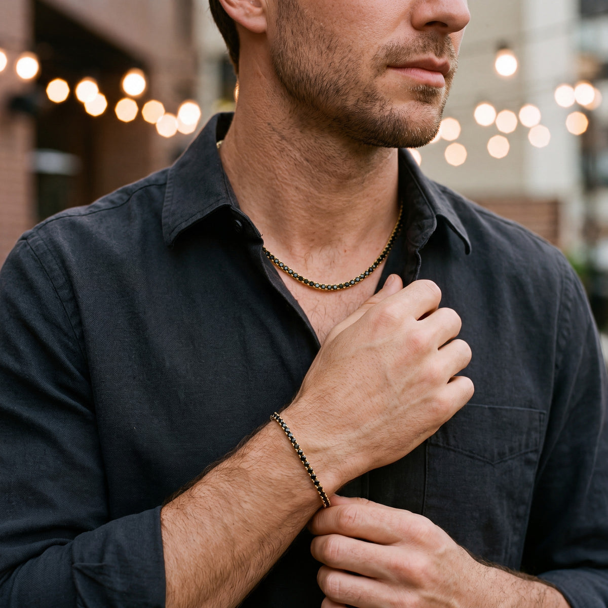 Man wearing the Onyx Dore tennis chain and Noi Golden bracelet together
