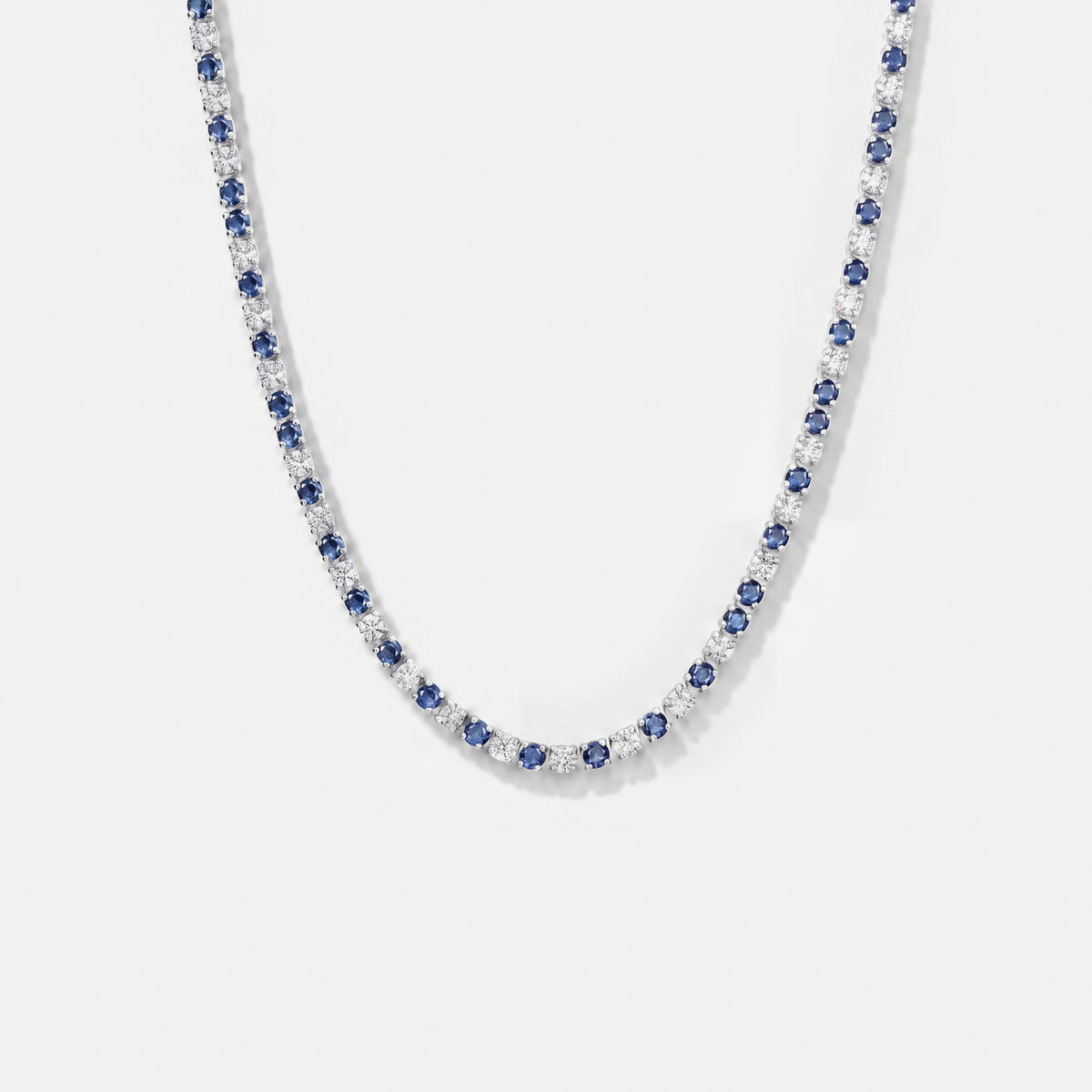 Aspen Marine tennis chain with alternating blue and white stones on a light grey background