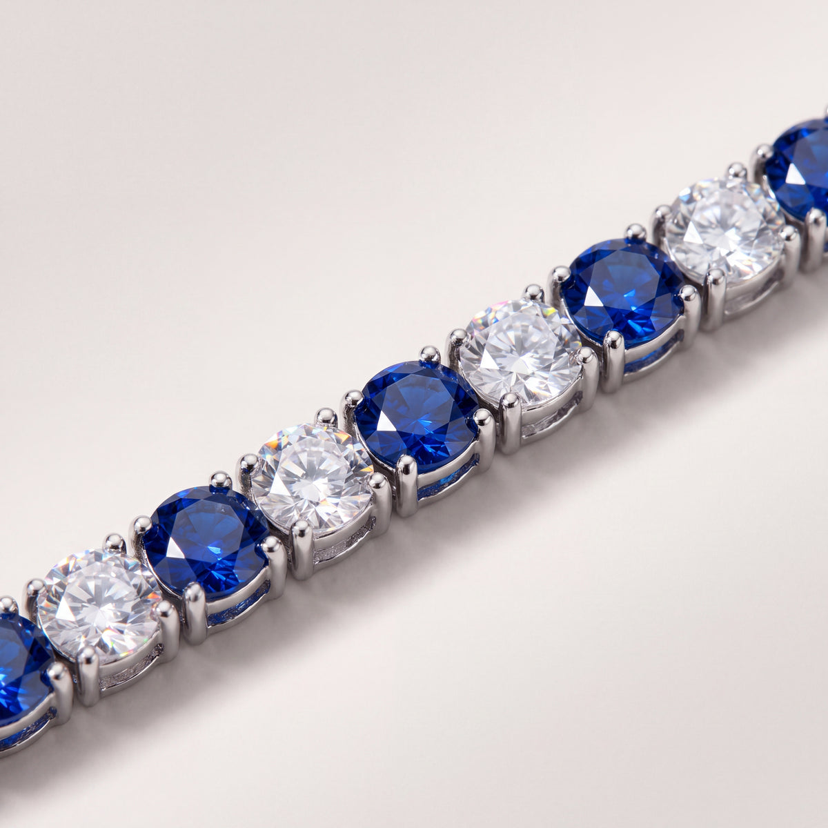 Macro detail of the Aspen Marine chain's alternating blue and white stones