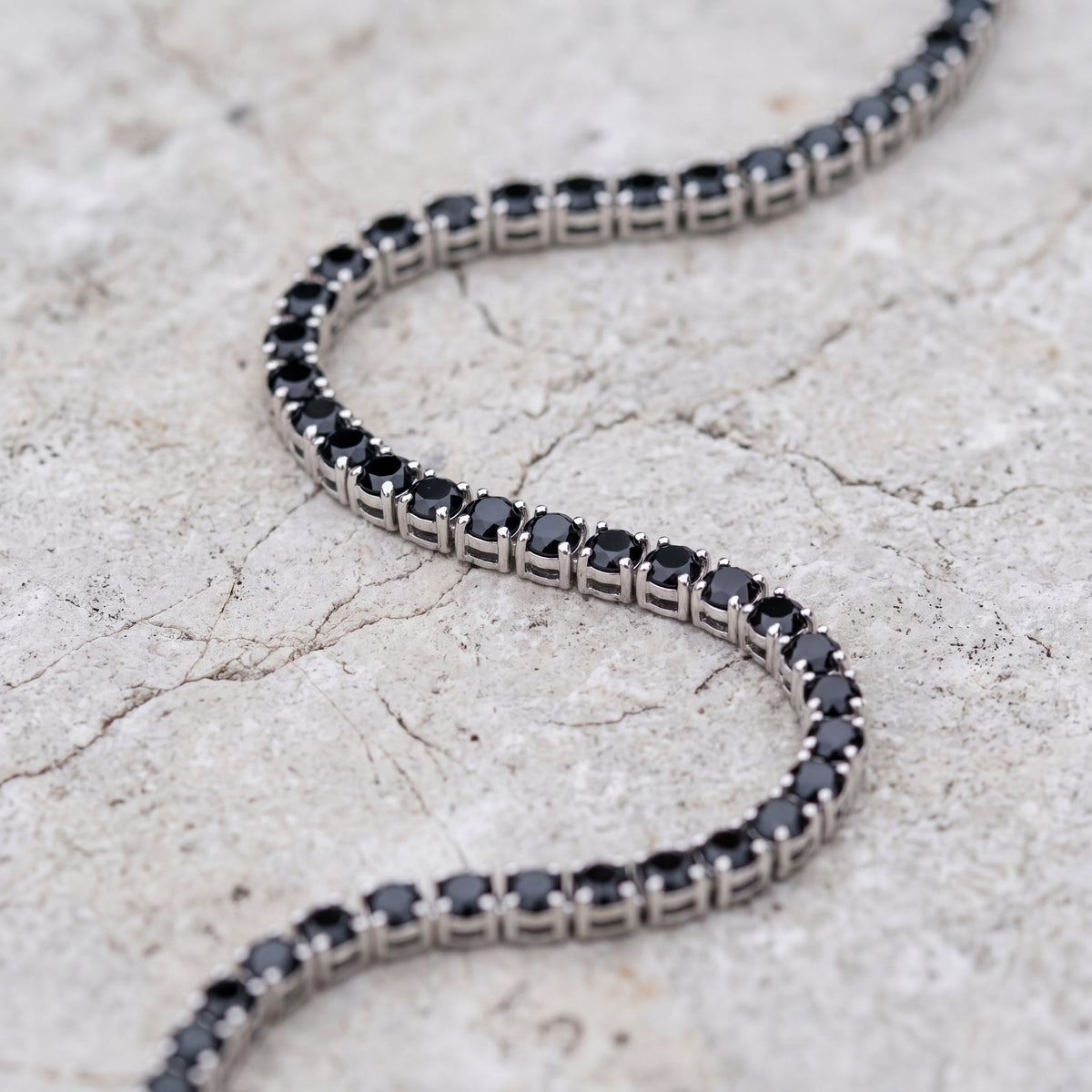 Onyx Chain laid on pale limestone