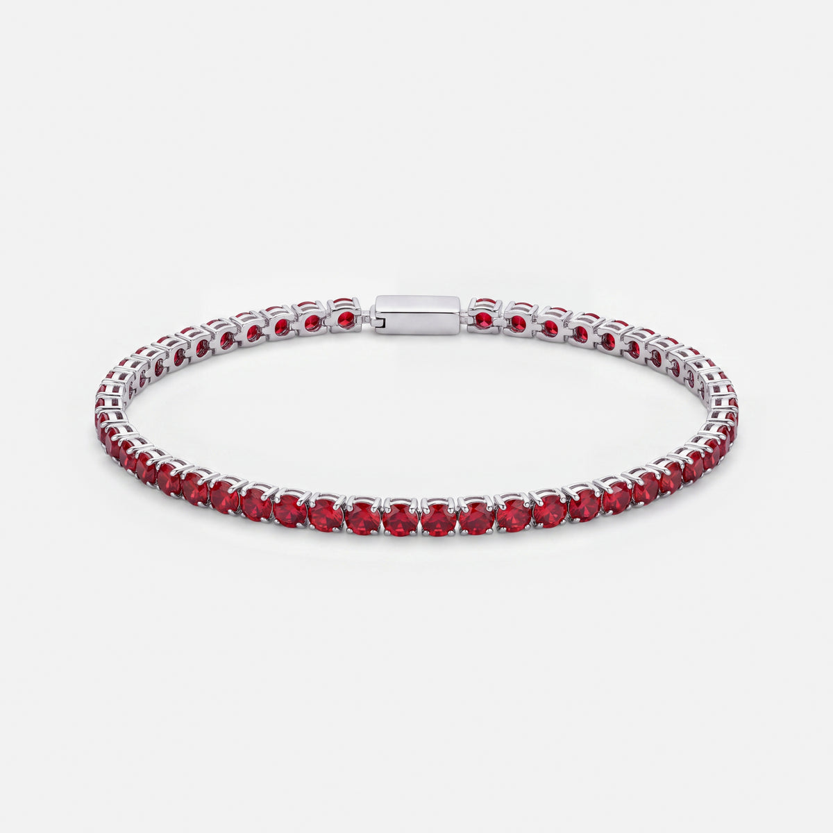 Rubi Garnet tennis bracelet, deep red stones in silver settings, on a light grey background