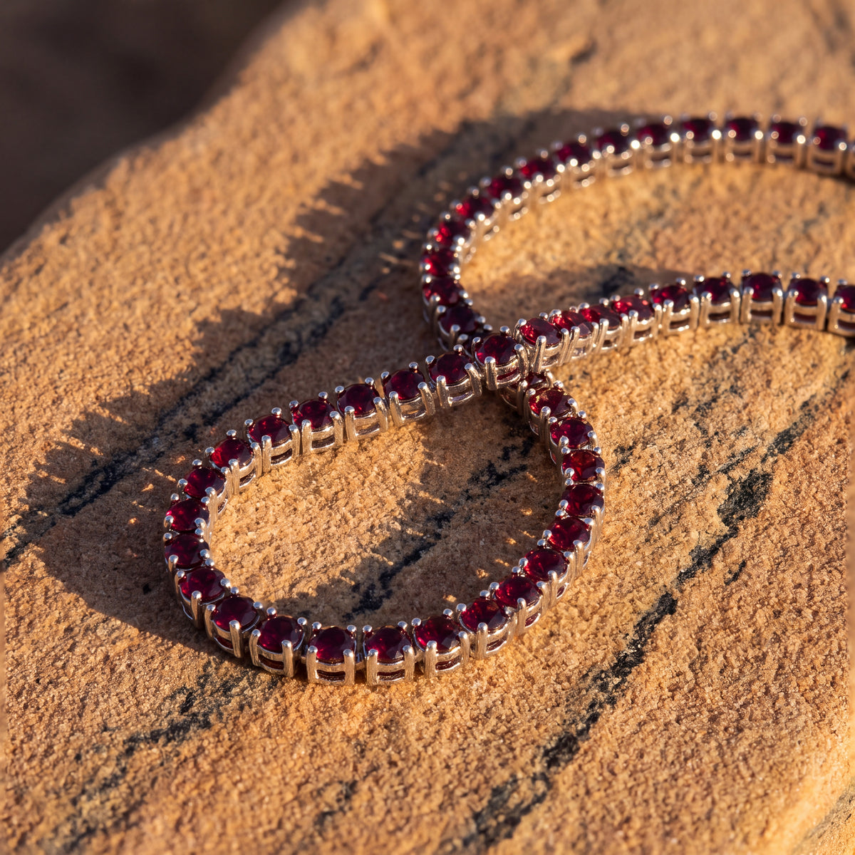 Rubi Garnet Chain laid on warm sandstone