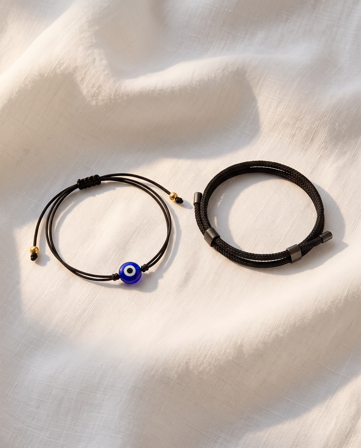 Greek Eye Cord and Porto Nautical Cord bracelets side by side on white linen fabric
