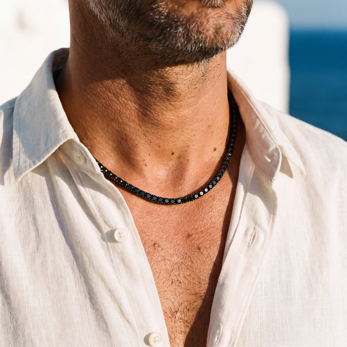 Vorn tennis chain worn at the collarbone with an open linen collar