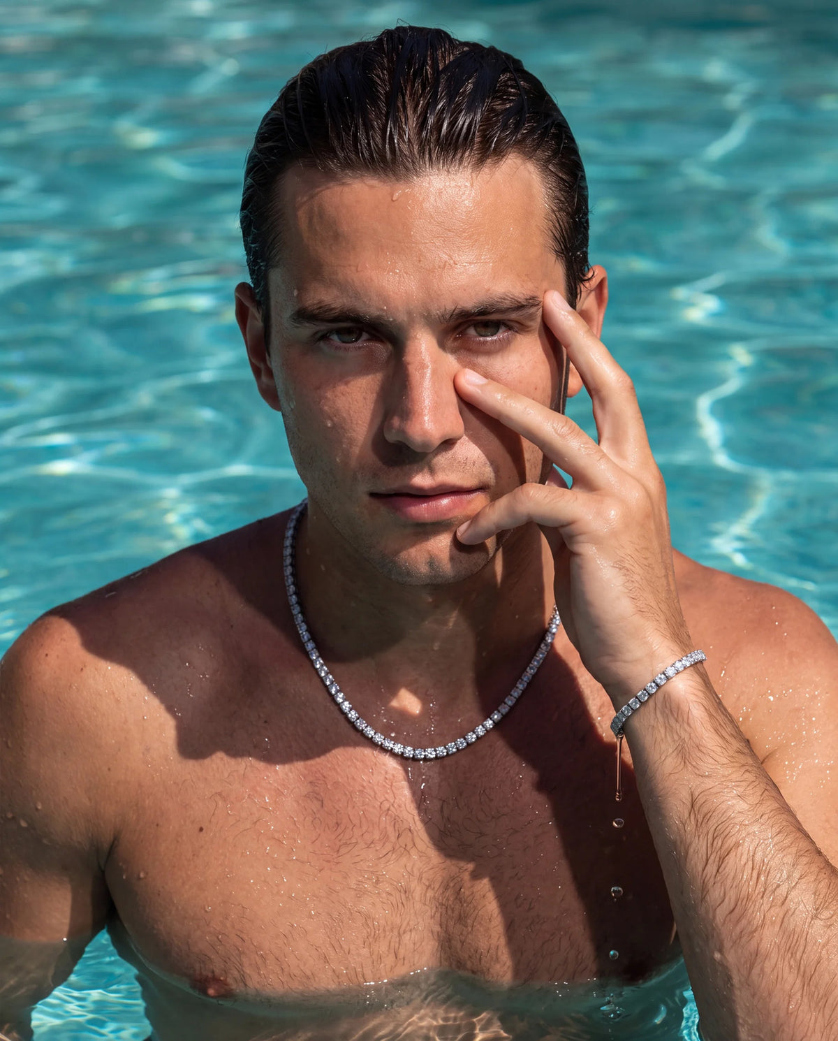 Man in a pool wearing the VORN tennis chain and tennis bracelet together