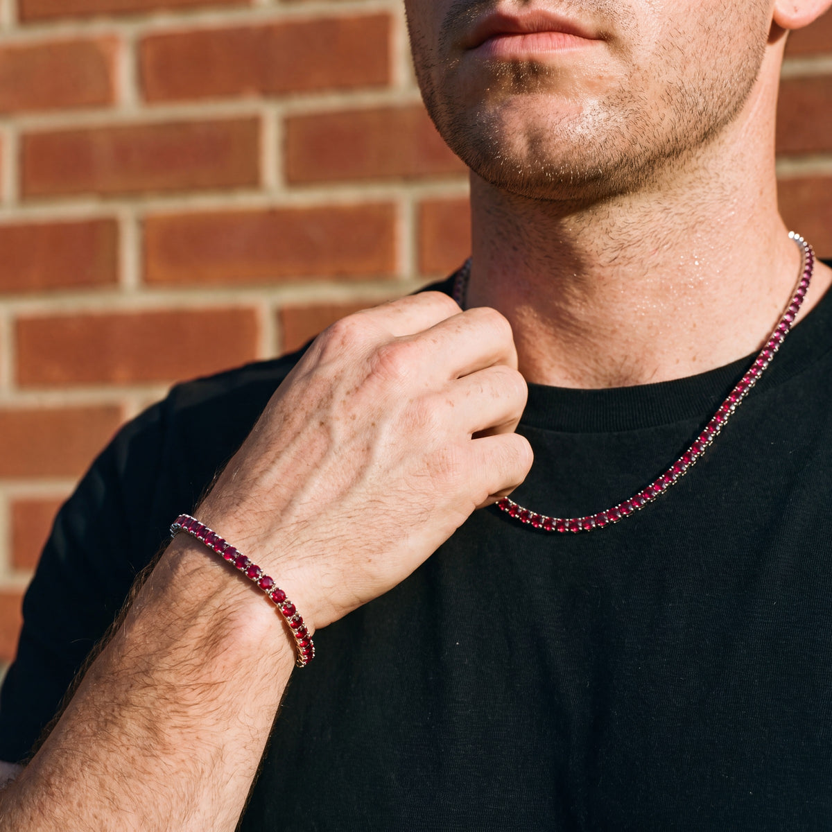 Man wearing the Rubi Garnet tennis chain and bracelet together